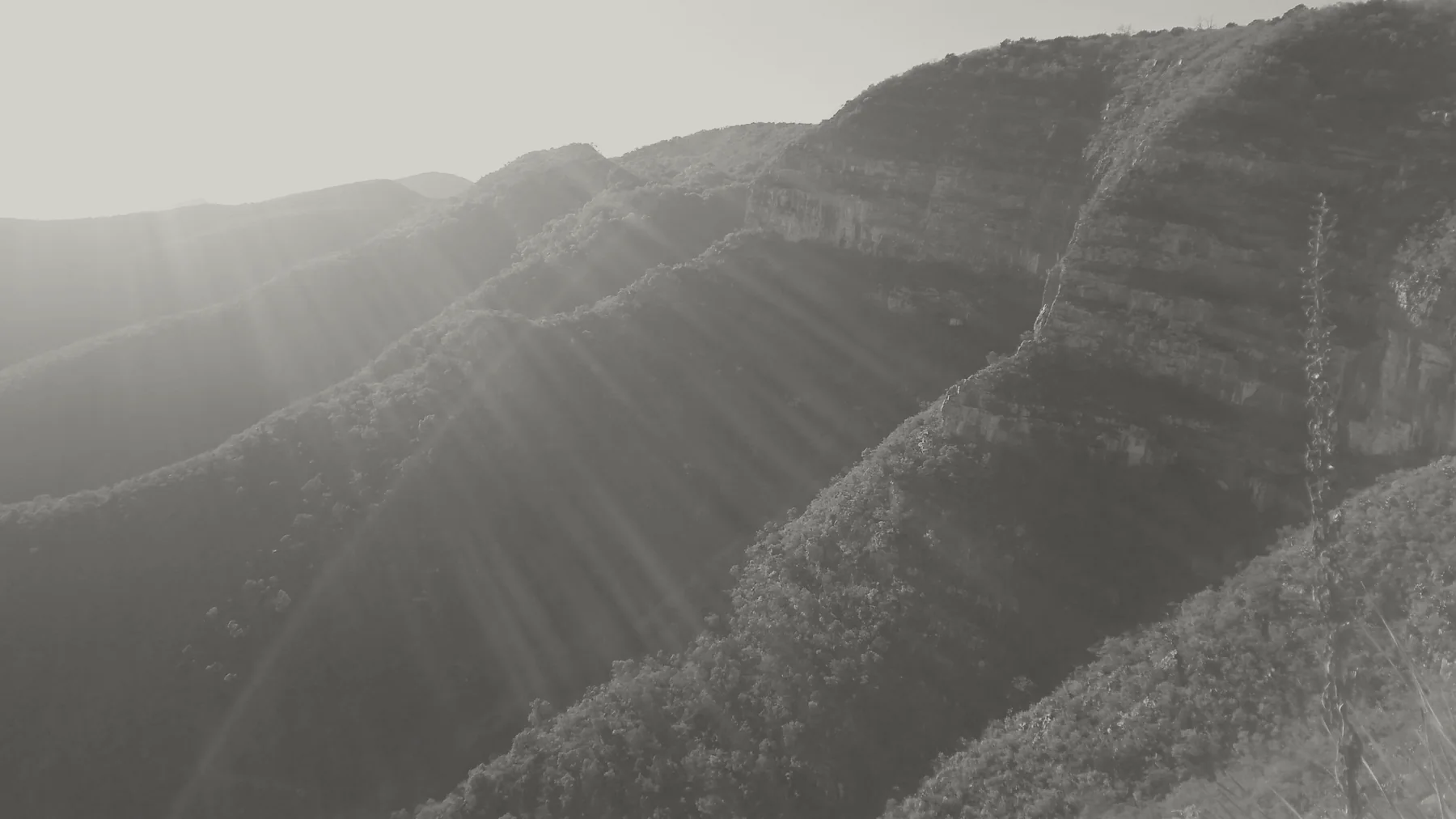 Sunlit mountain ridges and exposed rock faces.